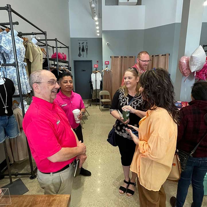 Small business owners networking at a ribbon cutting event